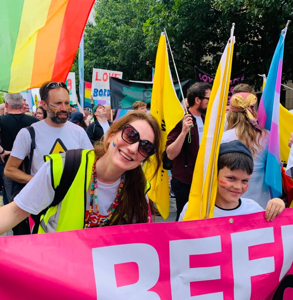 LCNI's Liz Griffith carries a 'Refugees Welcome' banner at Belfast Pride festival in 2022