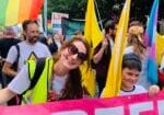 LCNI's Liz Griffith carries a 'Refugees Welcome' banner at Belfast Pride festival in 2022